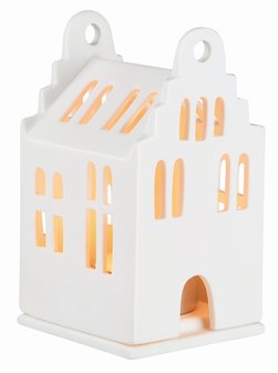 het brandende kleine witte porseleinen lichthuisje met zadeldak van Rader